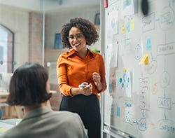 Executive Director presenting sales information in conference room - 250 px wide