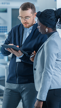 Female engineer and male supervisor looking at a tablet