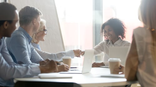 Female executives shaking hands during deal agreement