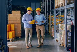 Two men walking through a manufacturing facility